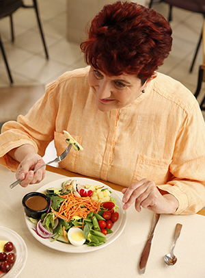 Woman eating salad.