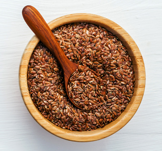 Bowl of flaxseed, with wooden spoon